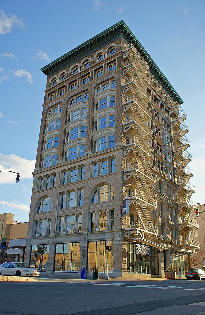 A privately-owned, commercial building on Washington Avenue and Spruce Street, across the street from the Veterans Plaza.