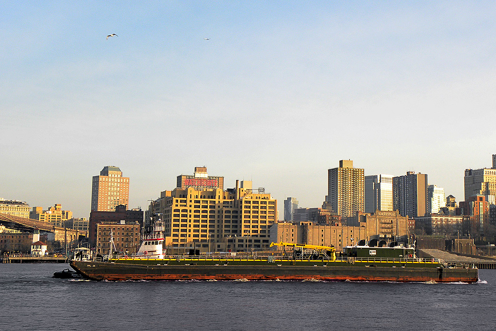 Barge with Brooklyn skyline in the background. Vi took this photo.