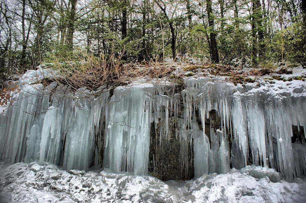Icicle formation on naturally-formed rock ledges by the roadside.